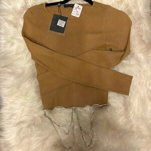 This is a large size tan crop sweater with rhinestones.